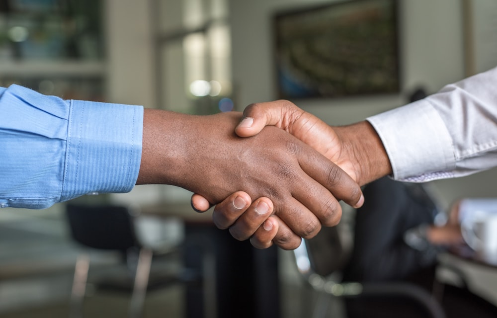 Writer and client sealing a successful resume handoff